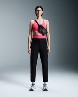 Woman wearing a pink sports bra and black pants with a black bag on a gray background - On Waist Pack 2L Lite - Magnet