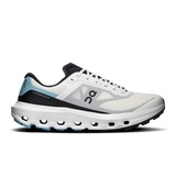 A side profile view of an On Cloudrunning shoe in white, black, and light blue. The shoe features a white mesh upper with black overlays, a black logo, and a light blue heel accent, set against a clean white background. - On Cloudvista 3 Shoes (Men's) - Ivory/Wash