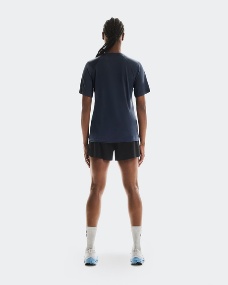 Person wearing a navy blue athletic outfit on a white background - On Trail-T (Women's) - Navy
