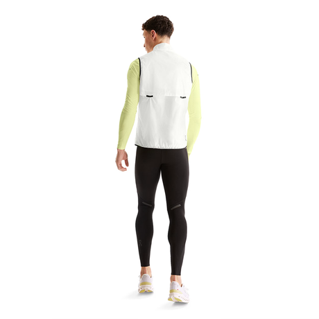 Person wearing a white vest, green long-sleeve shirt, black leggings, and white shoes on a white background - On Weather Vest (Men's) - White/Black