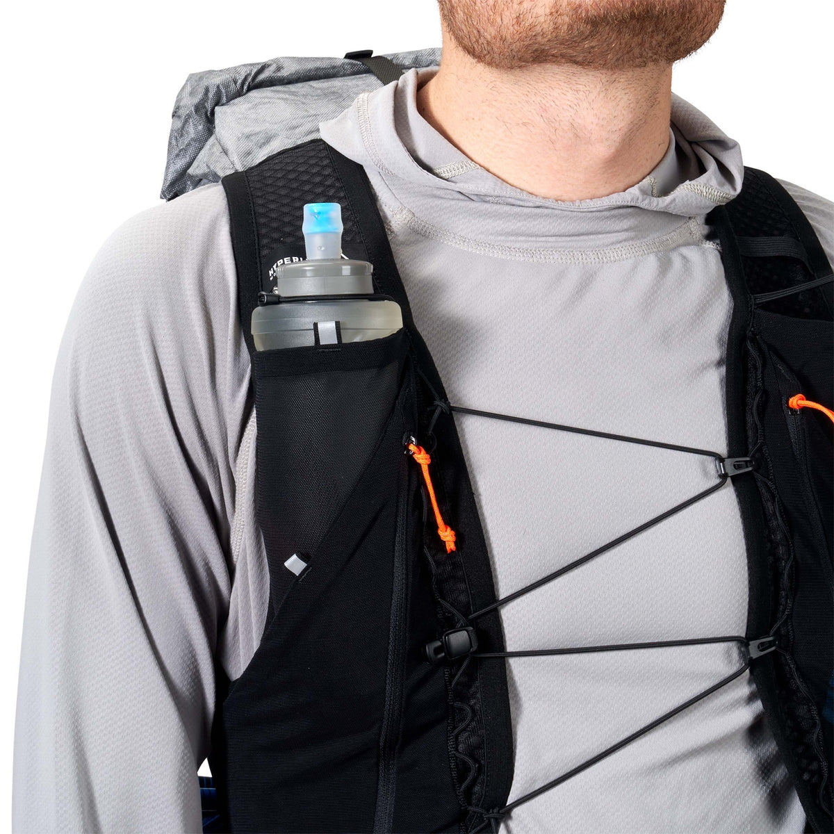 Person wearing a black backpack with a water bottle holder on a white background - Hyperlite Mountain Gear Pemi 15 Backpack