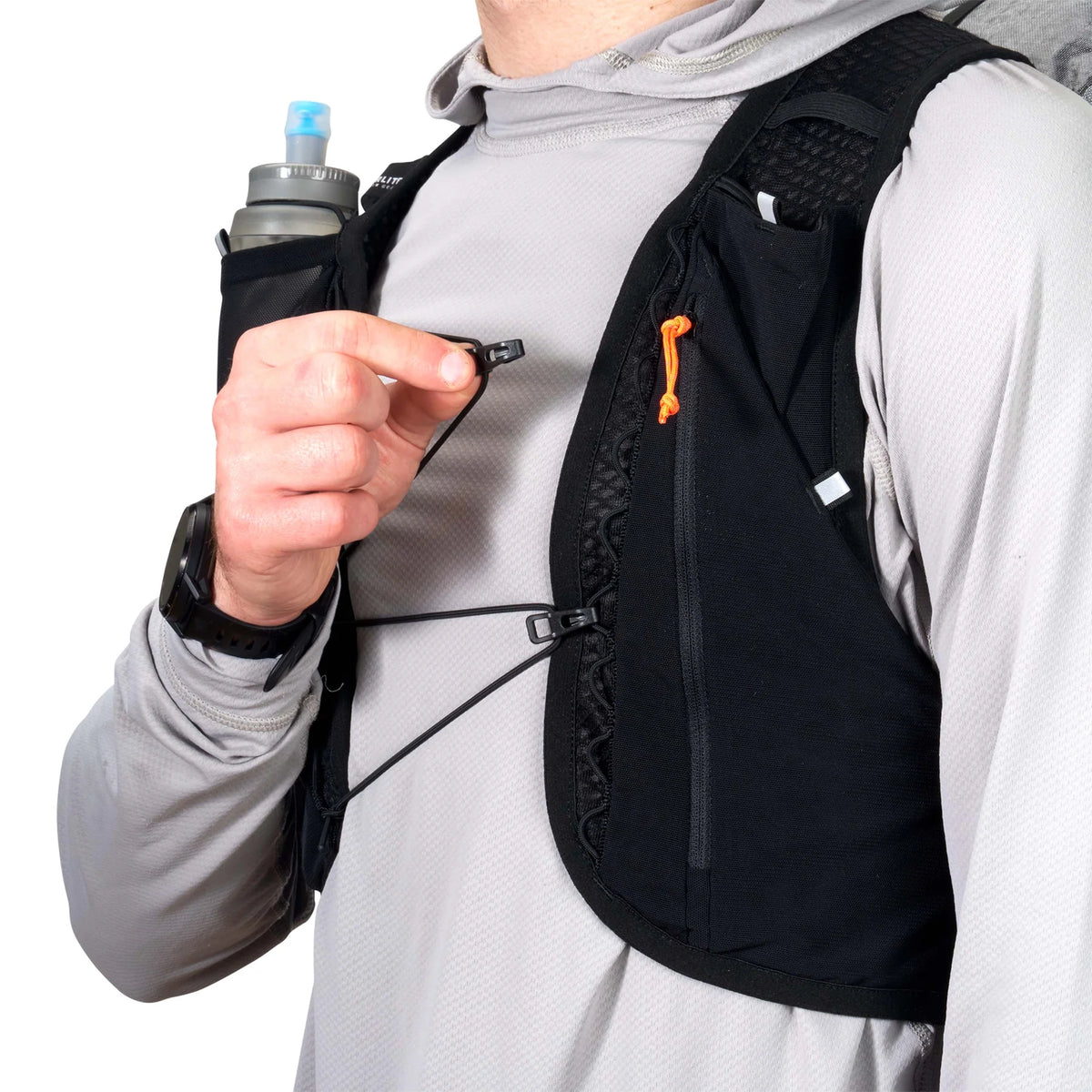 Person wearing a black hydration backpack with a water bottle and phone holder on a white background - Hyperlite Mountain Gear Pemi 15 Backpack