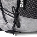 Close-up of a gray backpack with black straps and a brand logo on a white background - Hyperlite Mountain Gear Pemi 15 Backpack