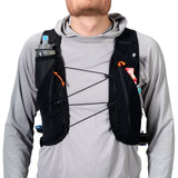 Person wearing a black hydration vest with multiple pouches on a white background - Hyperlite Mountain Gear Pemi 15 Backpack