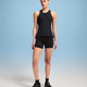 Person wearing a black tank top and shorts on a gradient background - On Performance Tank (Women's) - Black/Eclipse