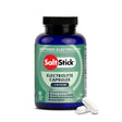 A bottle of Salt Stick Buffered Electrolytes + Caffeine electrolyte capsules, shown with two white capsules in front on a clean white background. - SaltStick Race Ready Capsules