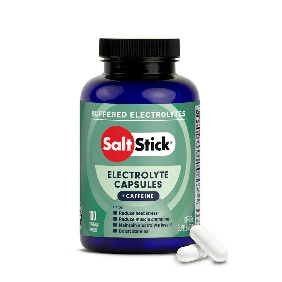 A bottle of Salt Stick Buffered Electrolytes + Caffeine electrolyte capsules, shown with two white capsules in front on a clean white background. - SaltStick Race Ready Capsules