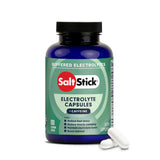 A bottle of Salt Stick Buffered Electrolytes + Caffeine electrolyte capsules, shown with two white capsules in front on a clean white background. - SaltStick Race Ready Capsules