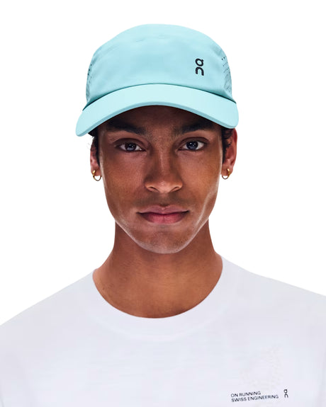 A man wearing a light blue P.C Sports baseball cap and a white t-shirt, shown from the chest up against a plain white background. - On Lightweight Cap - Wash